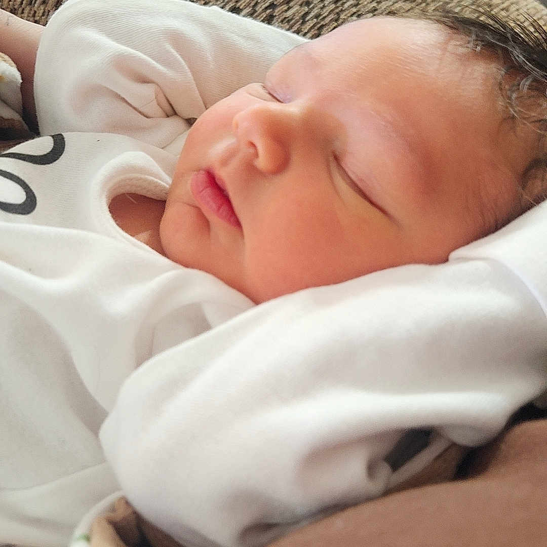 Louis joined the competition — help win amazing prizes! baby, sleeping, infant, white_clothing, couch, texture, face, peaceful, rest, indoor, closeup, soft_light, newborn, person, portrait, relaxation, cozy, child, skin, head