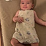 Elio participe au concours pour gagner de l'argent avec cette photo : baby, infant, child, romper, pillow, cushion, bed, sleeping_area, soft_surface, foot, hand, face, eyes, smile, clothing, patterned_clothing, indoor, furniture, cute, lying_down