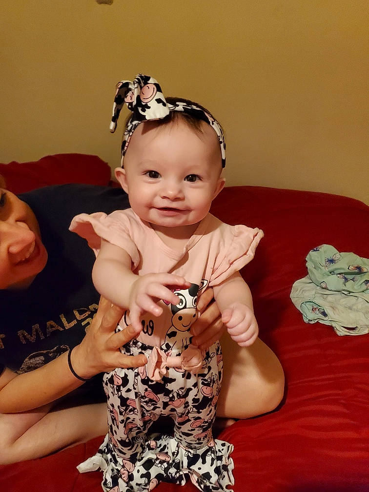 Marlee is registered to the contest to win money with this photo: baby, baby_toddler_clothing, child, costume_hat, event, face, fashion_accessory, gesture, happy, headband, headgear, headpiece, iris, jewellery, joy, neck, necklace, person, pink, sleeve