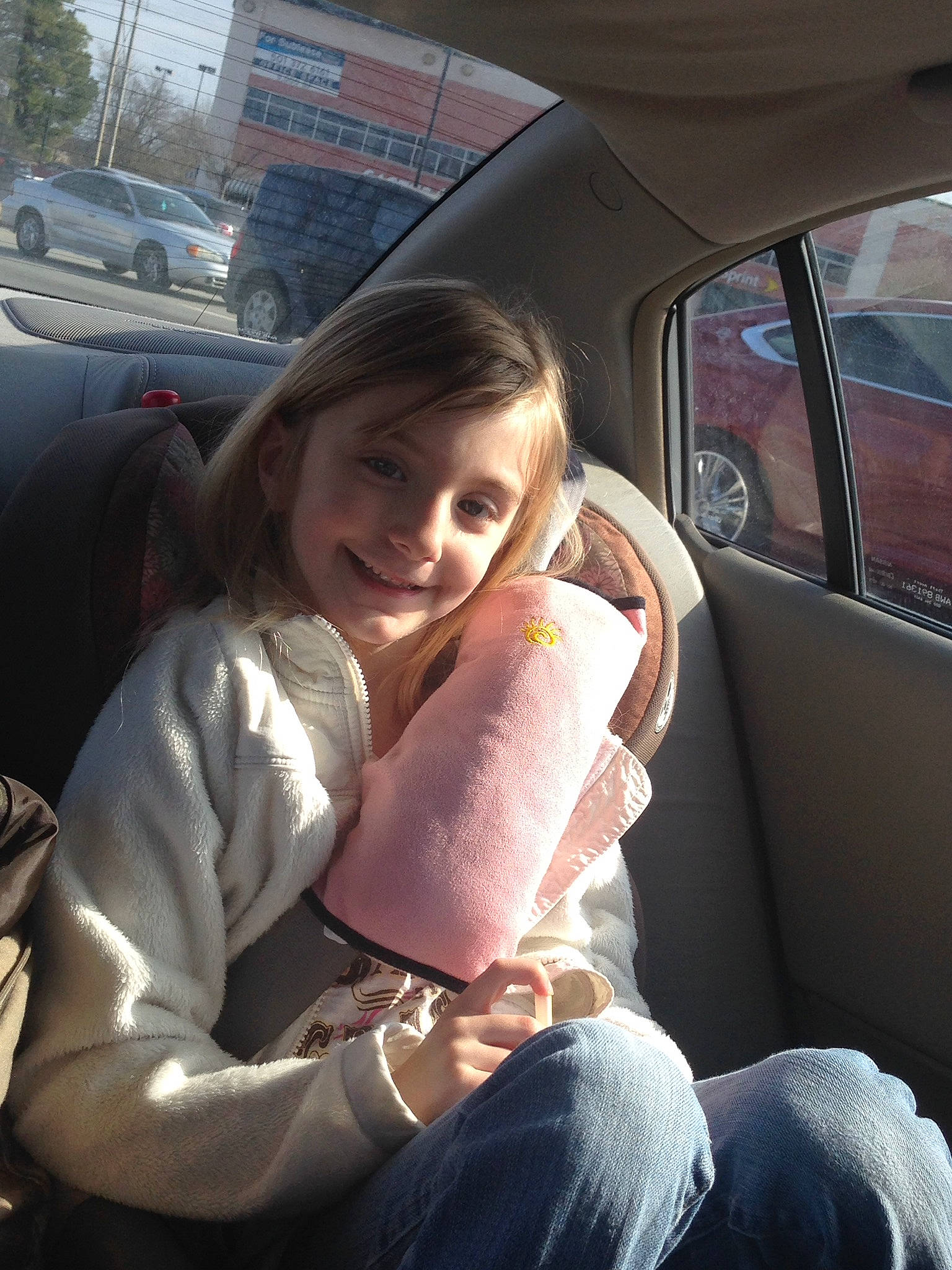 Lorraine is registered to the contest to win money with this photo: car, car_seat, child, driving, family_car, joy, person, smile, steering_wheel, vehicle, vehicle_door