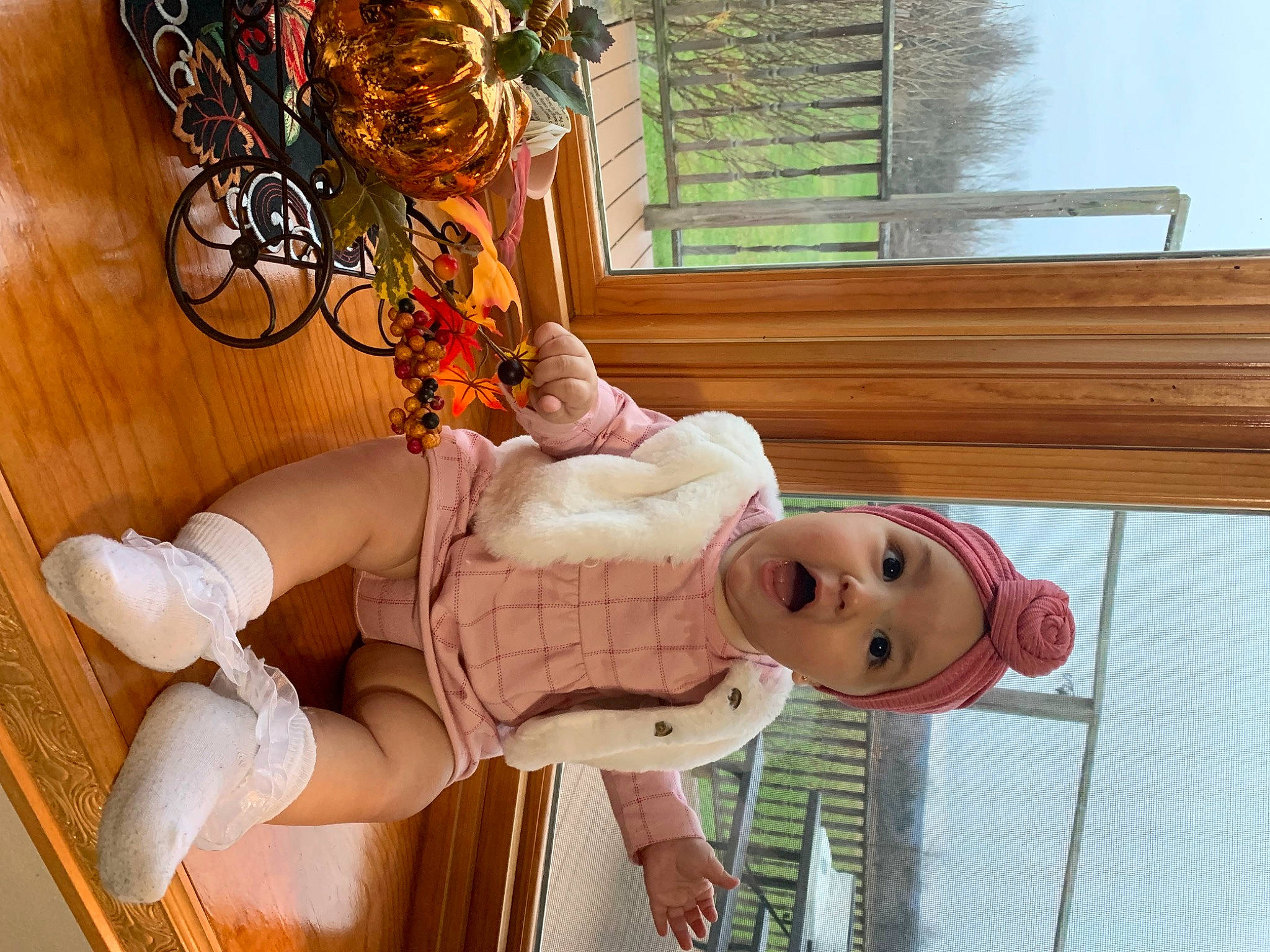 Avah is registered to the contest to win money with this photo: flowerpot, happy, hat, headwear, houseplant, human_leg, knee, peach, person, room, sandal, smile, sock, surprise, thigh, toy, white, window, wood, wrist