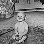 Diego is registered to the contest to win money with this photo: baby, child, infant, smiling, sitting, blanket, sippy_cup, indoor, carpet, tent, curtains, clothes, window, radiator, happy, playful, cute, sock, monochrome, portrait