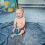 Diego is registered to the contest to win money with this photo: baby, child, smiling, indoor, carpet, blanket, toy, play_tent, living_room, window, curtains, laundry, sock, diaper, floor, happy, cute, infant, person, home