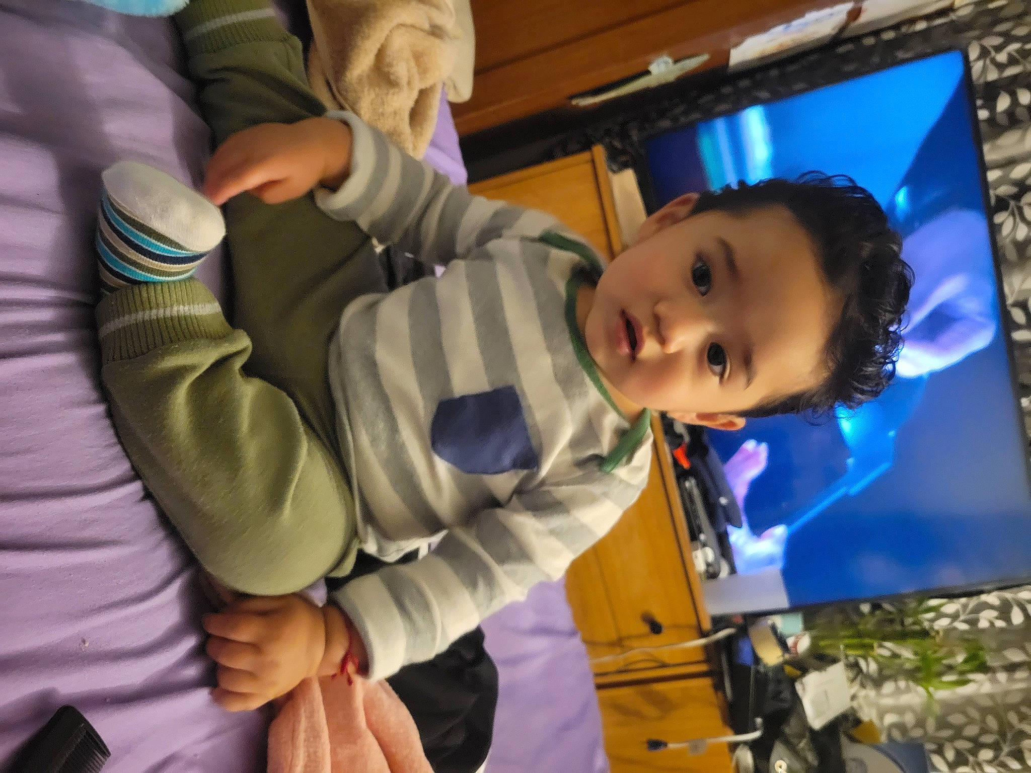 Abel is registered to the contest to win money with this photo: baby, child, entertainment, event, flash_photography, fun, gesture, happy, led_backlit_lcd_display, leisure, luxury_vehicle, person, play, purple, recreation, room, smile, television, toddler, tree