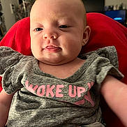 Brooklynn joined the competition — help win amazing prizes! baby, child, face, smile, clothing, shirt, red_background, indoor, person, cute, portrait, skin, head, young, infant, expression, seated, relaxed, casual, home