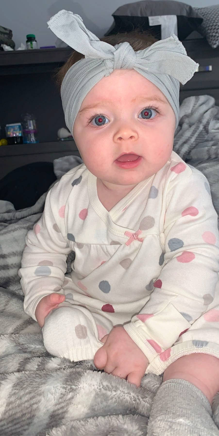 Mariyah is registered to the contest to win money with this photo: baby, cheek, child, eye, head, headgear, headwear, person, pink, skin, sleeve, smile, surprise, toddler