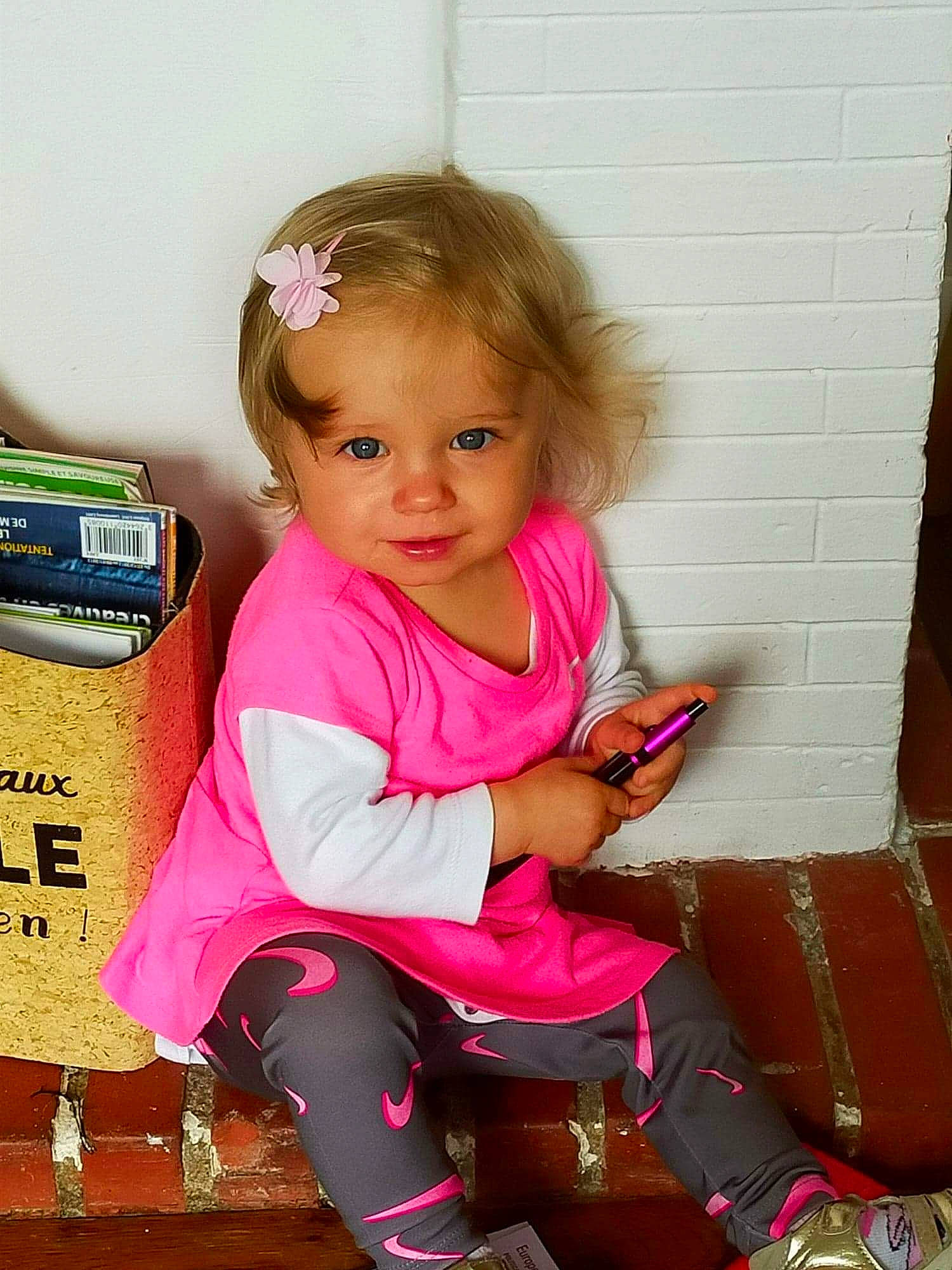 Kamila participe au concours pour gagner de l'argent avec cette photo : baby, baby_toddler_clothing, blond, cheek, child, eye, fun, happy, human_leg, knee, lip, magenta, person, pink, sitting, skin, sleeve, smile, sock, thigh