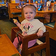 Kelianys Ross is registered to the contest to win money with this photo: toddler, child, baby, restaurant, high_chair, sitting, smiling, snack, food, minnie_mouse, bow, shirt, polka_dots, wooden_furniture, pendant_lights, booth, indoor, dining, portrait, happy
