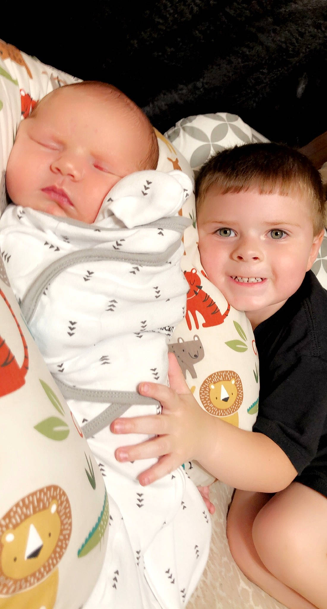 Levi is registered to the contest to win money with this photo: arm, baby_toddler_clothing, cheek, comfort, eye, face, facial_expression, finger, gesture, hand, head, joy, mouth, nose, person, product, skin, sleeve, smile, textile