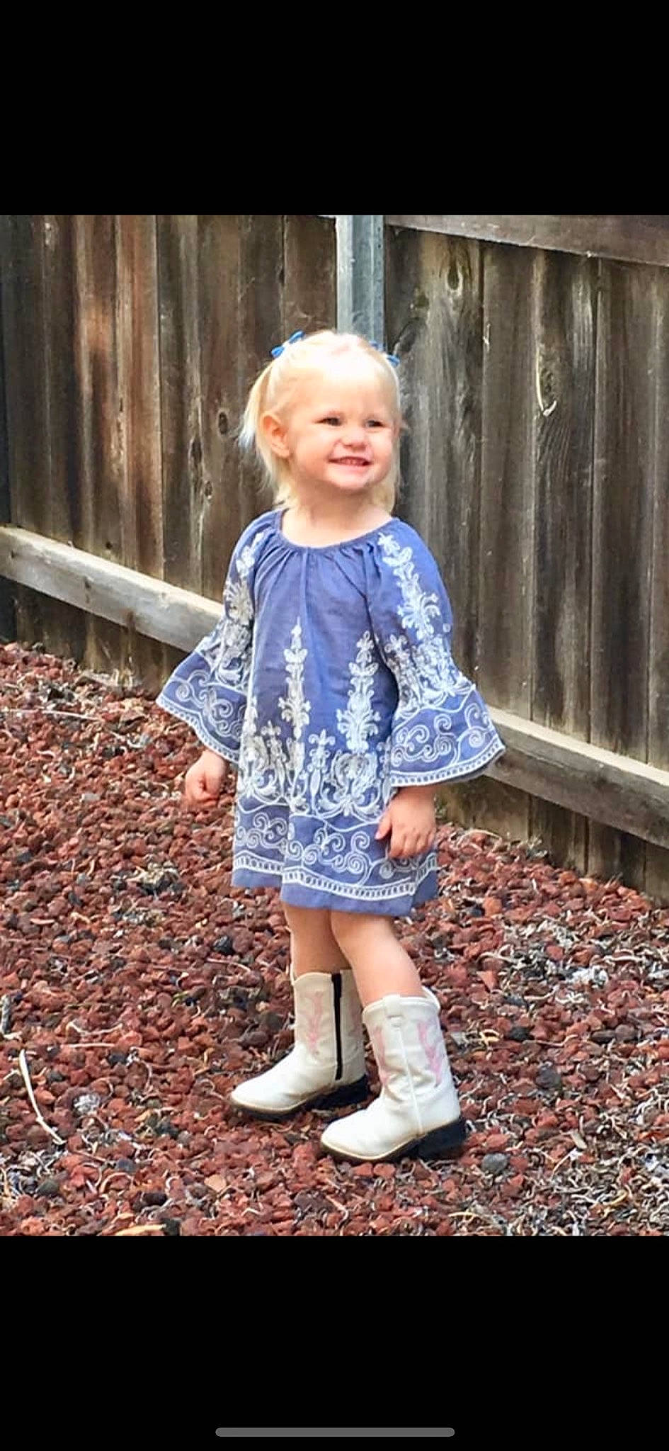 Kenley is registered to the contest to win money with this photo: boot, child, child_model, clothing, design, dress, footwear, outerwear, pattern, person, shoe, shorts, sitting, sleeve, standing, toddler