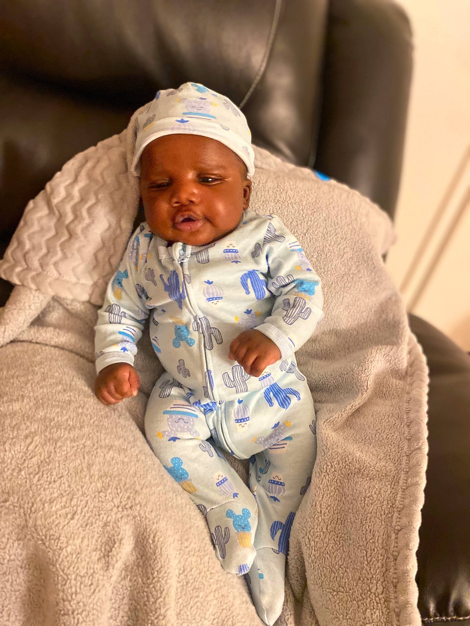 Hassan is registered to the contest to win money with this photo: baby, baby_products, baby_sleeping, baby_toddler_clothing, beanie, cap, cheek, child, comfort, eye, fun, happy, hat, headwear, linens, person, room, sitting, skin, sleeve