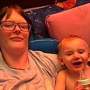 Alexander joined the competition — help win amazing prizes! adult, baby, bottle, cushion, glasses, happy, indoor, person, portrait, smile, space_theme, blanket, child, face, head, toddler, casual_clothing, relaxation, home, seated