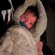 Darren is registered to the contest to win money with this photo: baby, blanket, pacifier, child, face, person, fur, cozy, warm, indoor, soft, clothing, hand, comfort, infant, wrapped, cute, portrait, newborn, resting