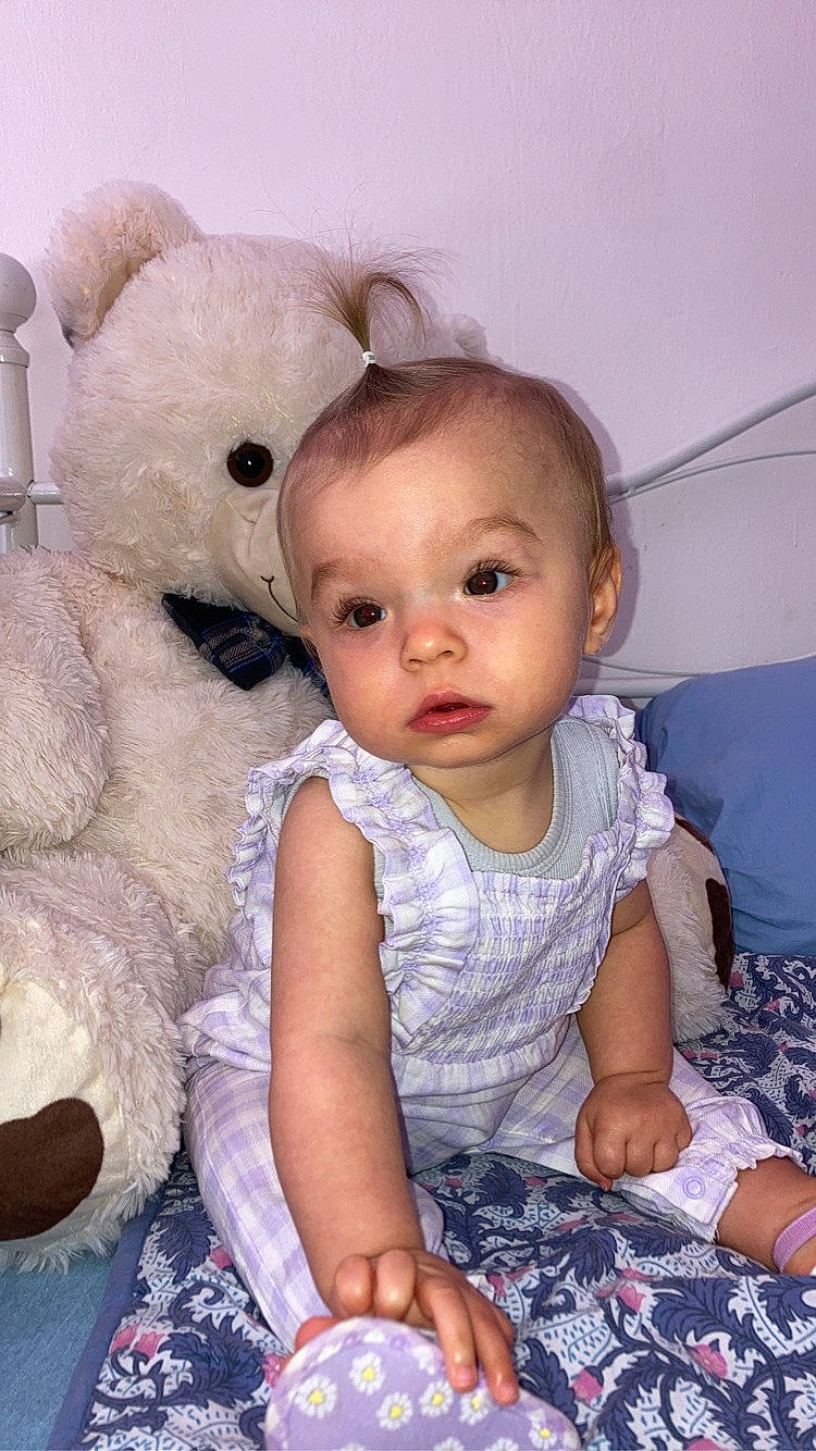 Nalya participe au concours pour gagner de l'argent avec cette photo : baby, baby_toddler_clothing, cheek, child, eyelash, fur, happy, head, iris, nose, organ, person, pink, sitting, skin, sleeve, stuffed_toy, teddy_bear, textile, toddler