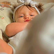 Sara joined the competition — help win amazing prizes! baby, infant, headband, blanket, closeup, face, blue_eyes, skin, cute, soft, cozy, child, young, indoors, portrait, expression, sleepwear, comfort, headwear, resting