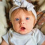 Sara joined the competition — help win amazing prizes! baby, infant, headband, blue_eyes, surprised_expression, clothing, blanket, soft_texture, face, portrait, child, cute, young, indoor, closeup, person, apparel, headwear, skin, newborn