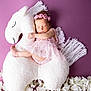Lena joined the competition — help win amazing prizes! adorable, baby, child, cozy, cute, decorative, floral, headband, infant, newborn, peaceful, pink_dress, plush_unicorn, portrait, purple_background, resting, sleeping, soft_texture, toddler, white_flowers