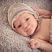 Lena is registered to the contest to win money with this photo: baby, infant, face, blanket, bonnet, lace, soft_texture, cute, skin, hand, portrait, lying_down, closeup, child, newborn, expression, cozy, comfortable, indoors, sleepwear