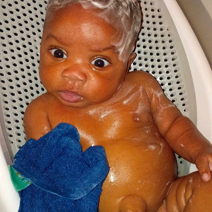 Javaughn is registered to the contest to win money with this photo: baby, soap, washcloth, bath, bathroom, seat, child, skin, water, cleaning, foam, cute, infant, toddler, expression, face, hand, wet, sitting, playful