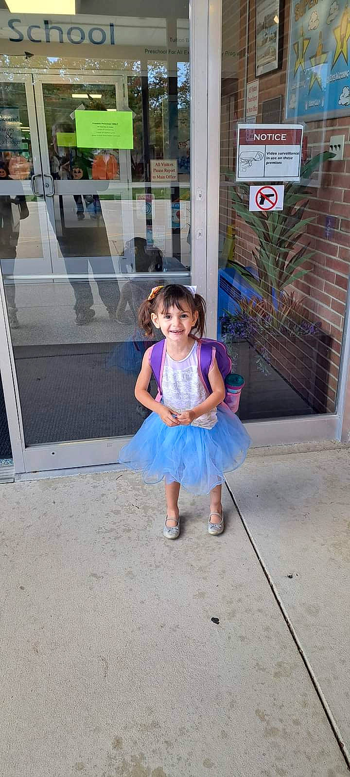 Adelynn joined the competition — help win amazing prizes! asphalt, child, dress, electric_blue, fun, human_leg, joy, leisure, magenta, pattern, pedestrian, person, pink, plant, recreation, road, road_surface, sandal, sidewalk, smile