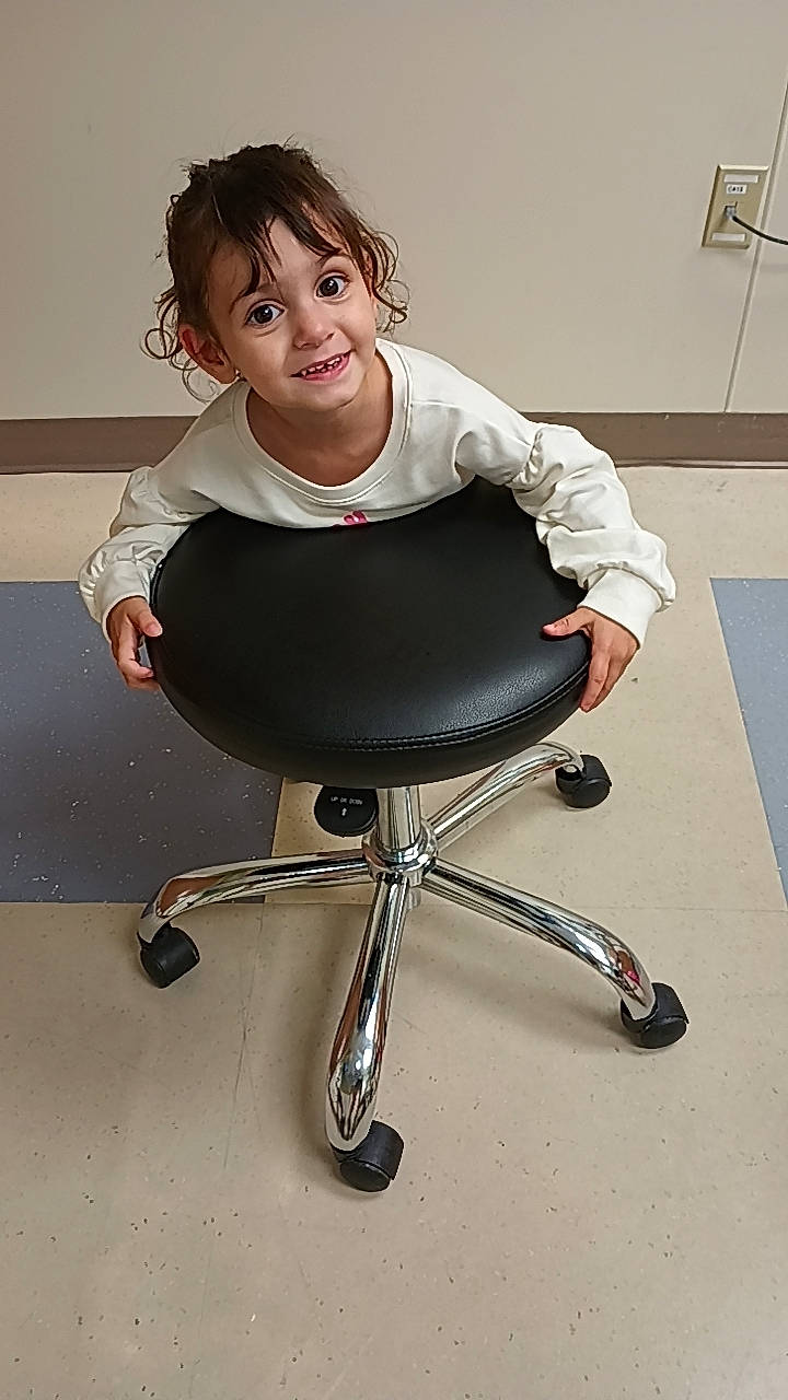 Adelynn is registered to the contest to win money with this photo: balance, chair, dress, eyewear, flash_photography, flooring, human_body, human_leg, joy, knee, office_chair, person, sandal, shoe, shoulder, sitting, sleeve, sportswear, t_shirt, thigh
