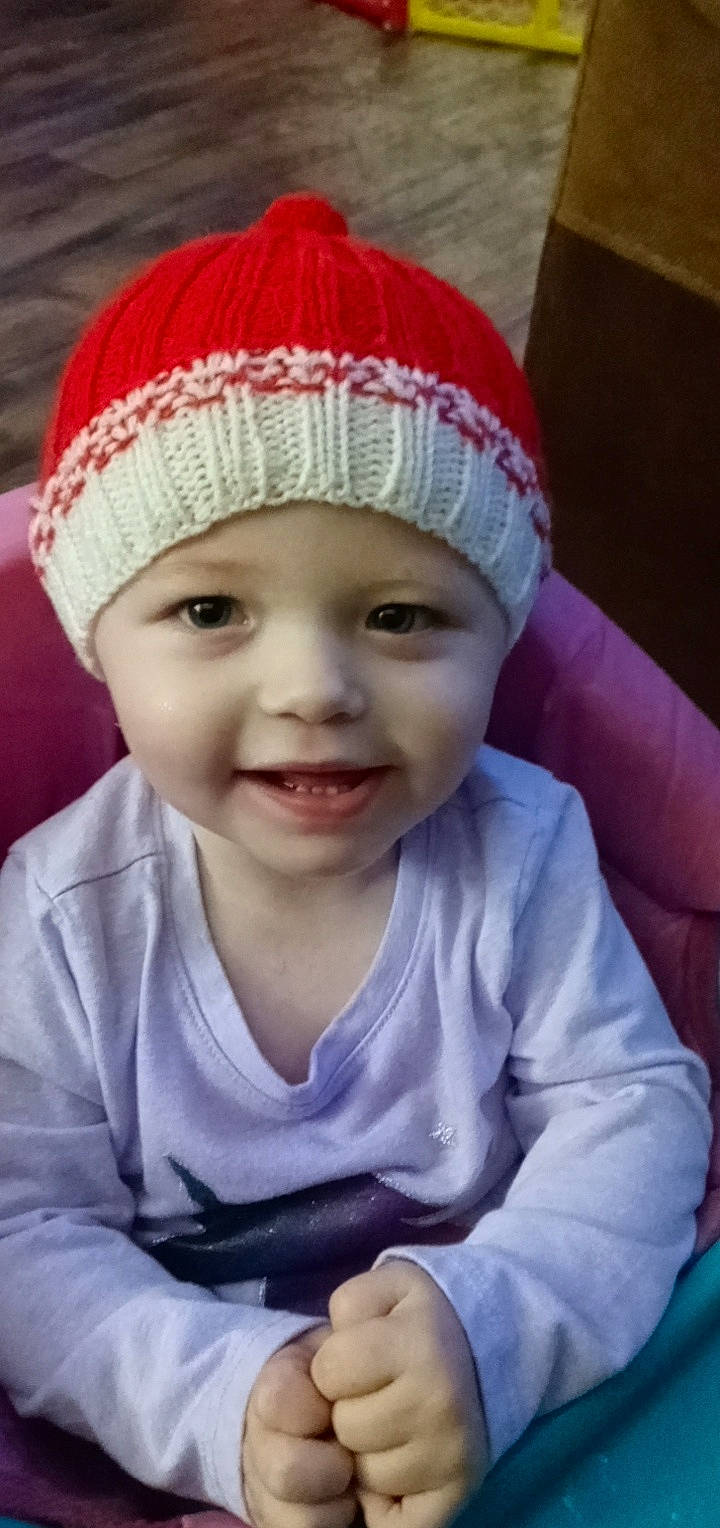 Ensley is registered to the contest to win money with this photo: baby, cap, cheek, chin, eye, eyebrow, face, happy, head, headgear, headwear, joy, lip, nose, organ, outerwear, person, pink, skin, sleeve