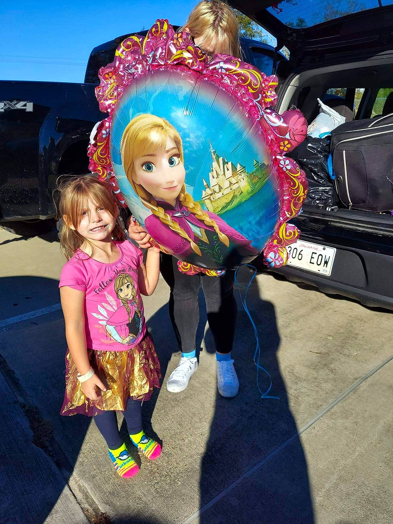 Carolyn is registered to the contest to win money with this photo: automotive_exterior, bumper, car, child, cool, entertainment, event, fun, happy, leisure, luxury_vehicle, magenta, motor_vehicle, person, pink, recreation, toddler, toy, travel, vehicle_door