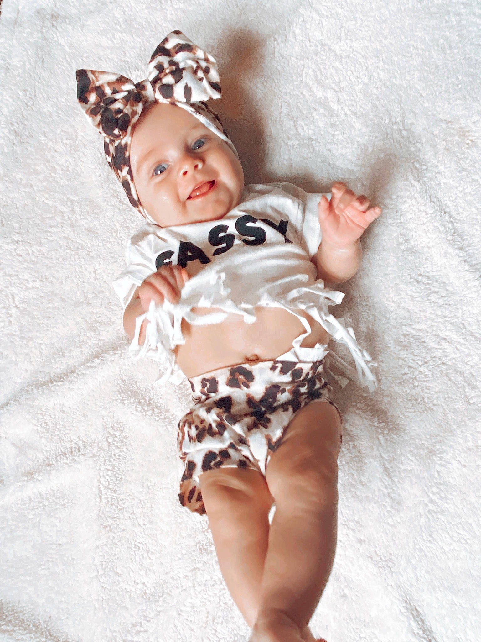 Everly is registered to the contest to win money with this photo: arm, baby, baby_toddler_clothing, cap, costume_hat, face, fawn, hand, hat, head, headwear, human_body, human_leg, neck, pattern, person, shorts, sleeve, sun_hat, textile