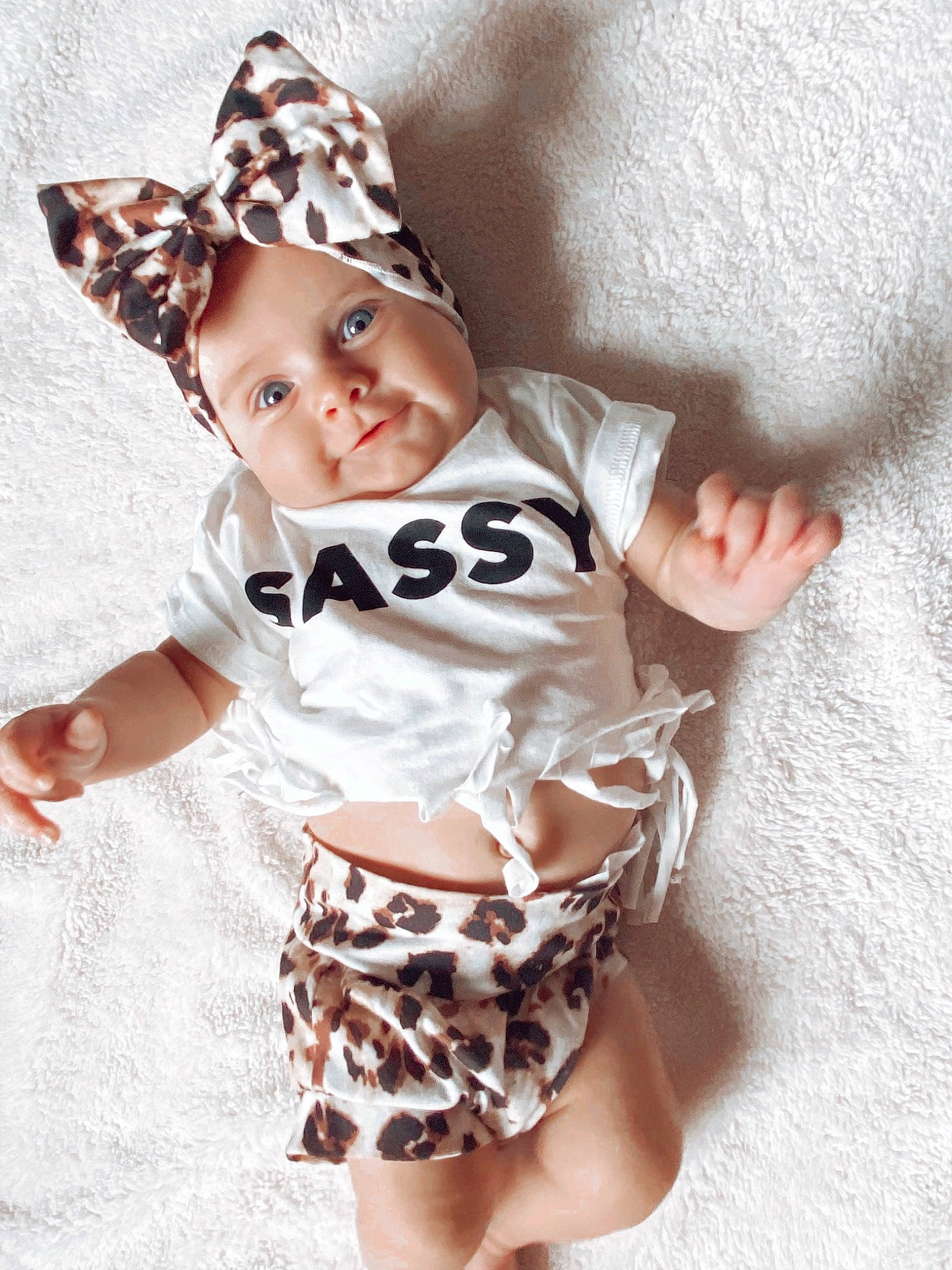 Everly is registered to the contest to win money with this photo: baby, baby_products, baby_toddler_clothing, child, collar, costume_hat, fashion_accessory, fedora, happy, hat, headwear, human_leg, linens, pattern, person, skin, sleeve, sun_hat, t_shirt, thigh