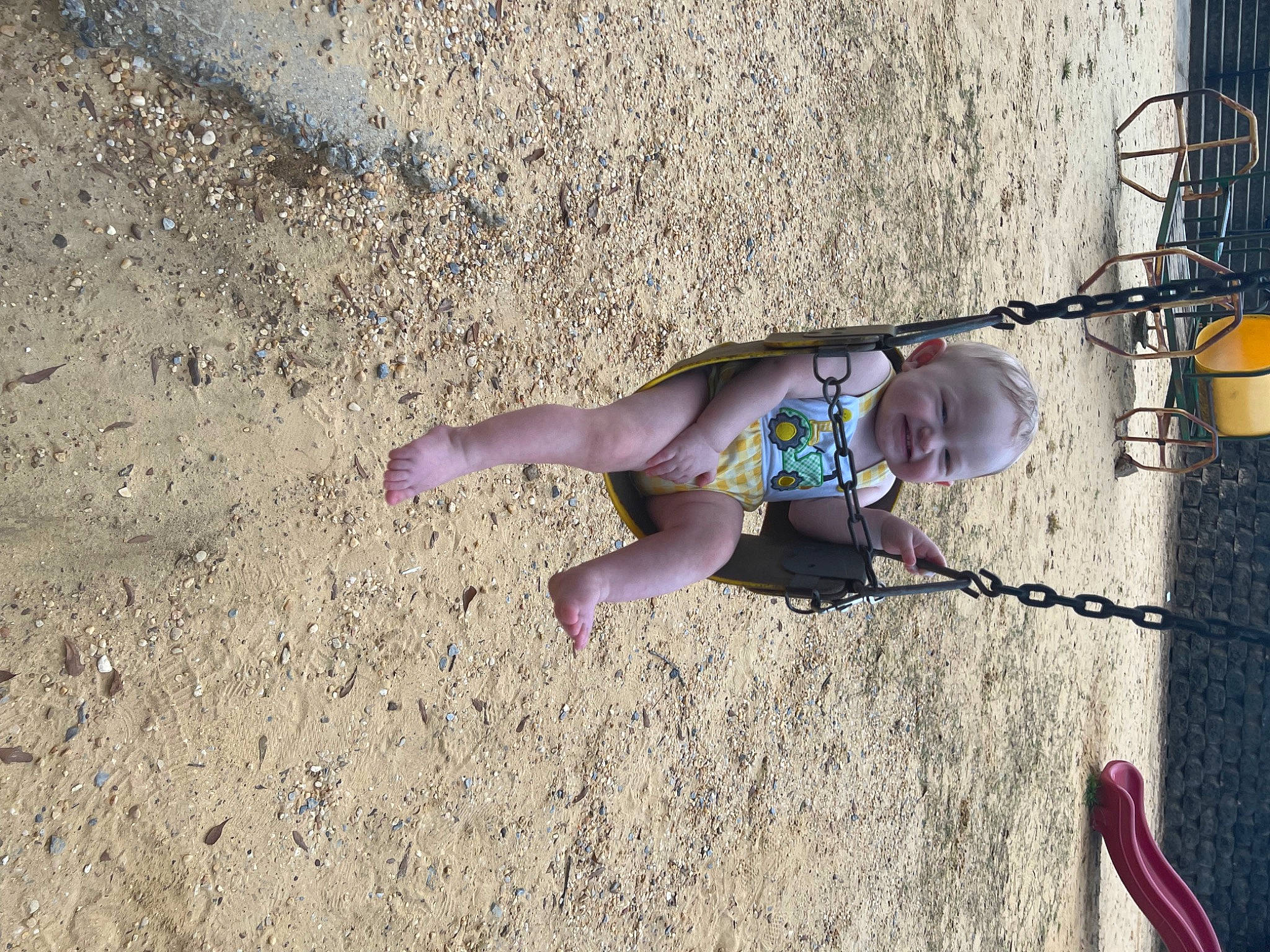 Ryder is registered to the contest to win money with this photo: child, concrete, foot, fun, human_body, human_leg, leg, leisure, people_in_nature, person, recreation, sand, shadow, sitting, smile, soil, sunglasses, toddler, tree, water
