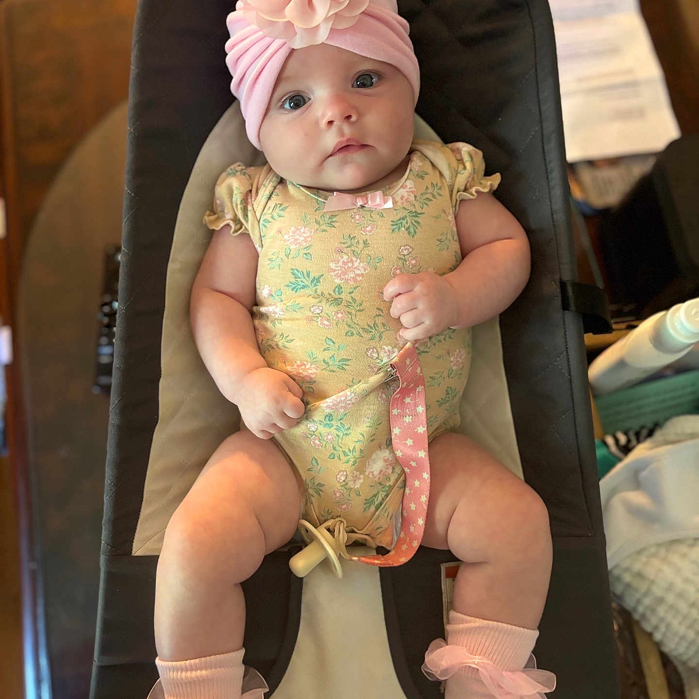 Estaleen joined the competition — help win amazing prizes! baby, baby_fashion, baby_seat, child, chubby_arms, chubby_legs, clothing, cute, floral_onesie, headwear, human, indoor, infant, infant_accessory, looking_at_camera, pacifier, pink_hat, portrait, socks, soft_lighting