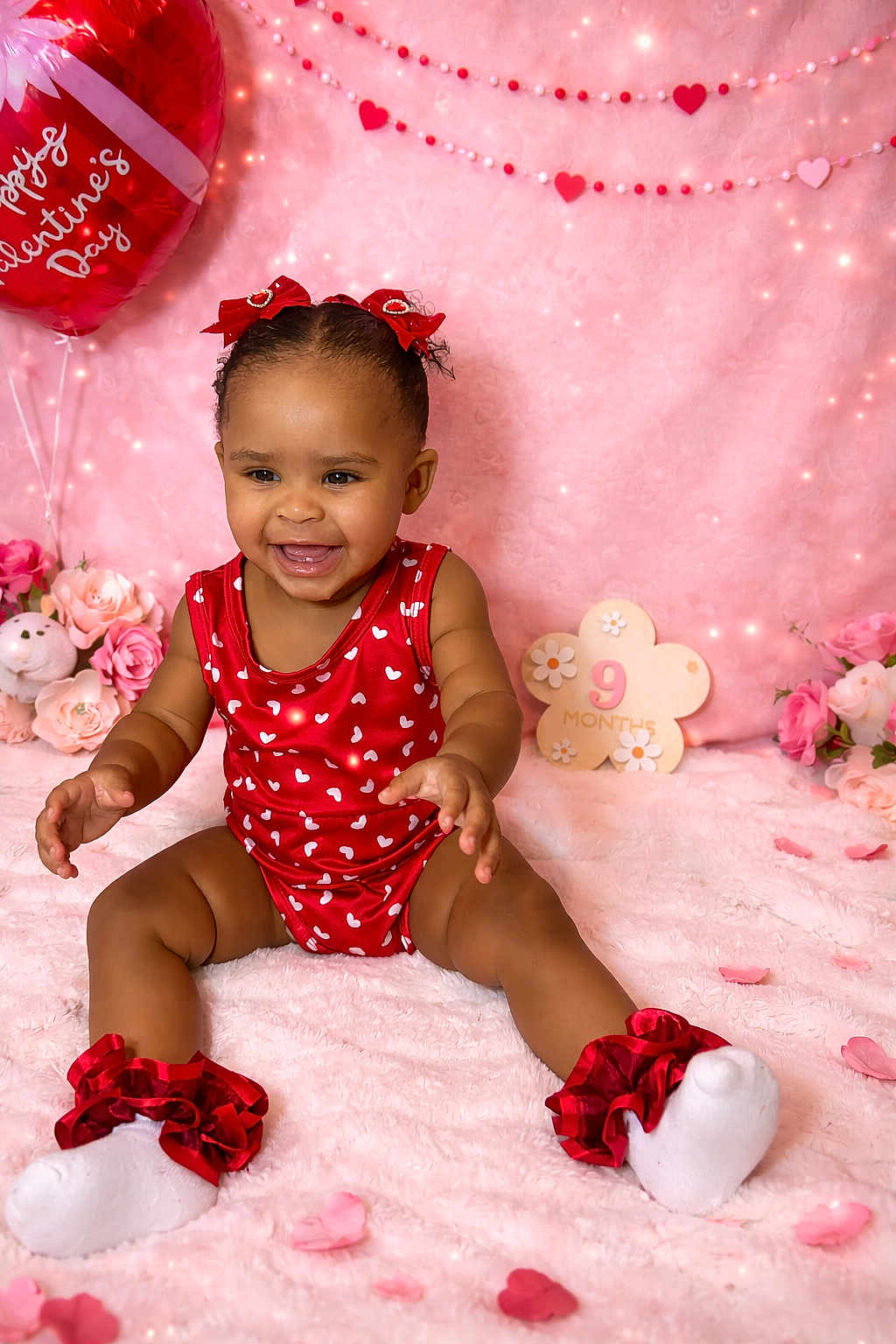 Iceelee is registered to the contest to win money with this photo: child, baby, infant, smiling, sitting, valentine, hearts, pink_background, balloon, flowers, plush_toy, onesie, socks, ruffles, portrait, milestone, petals, bow, cozy, studio