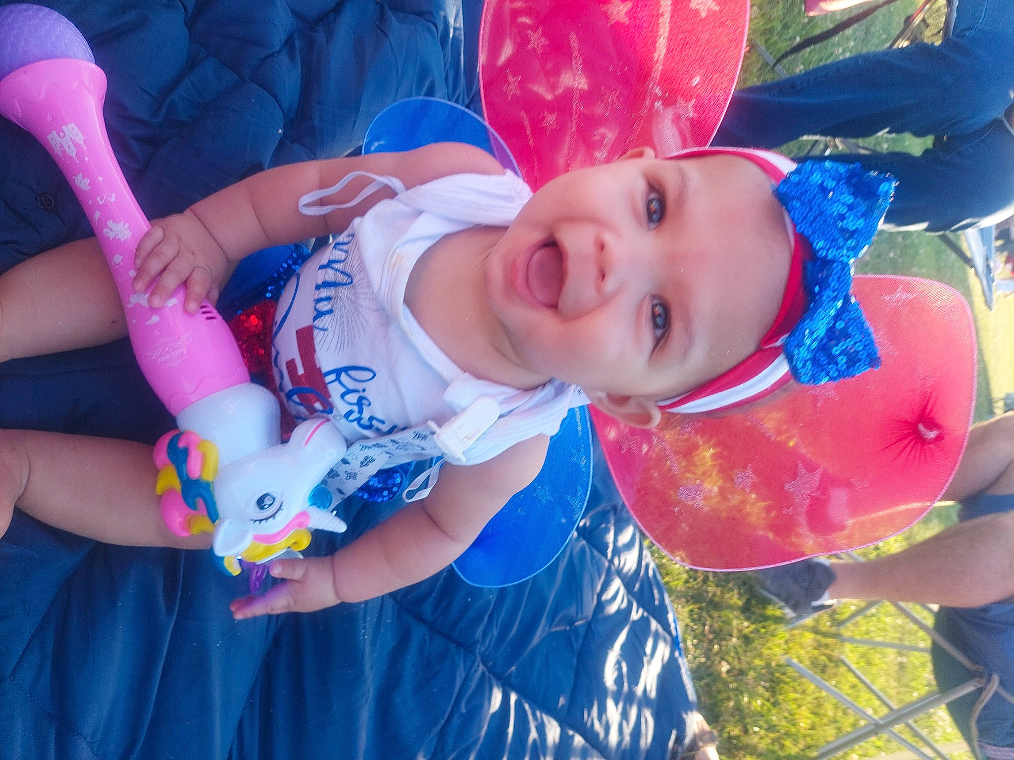 Arabelle joined the competition — help win amazing prizes! baby, baby_toddler_clothing, blue, child, electric_blue, event, finger, fun, grass, happy, hat, headwear, leisure, party_supply, person, pink, play, recreation, red, smile