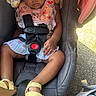 toddler, sleeping, car_seat, child, outdoor, sandals, clothing, seatbelt, floral, headrest, baby, rest, sunlight, bag, bottle, asphalt, cute, peaceful, portrait, childcare