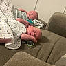 baby, newborn, sleeping, blanket, couch, indoor, peaceful, child, infant, resting, home, cozy, soft_lighting, two_babies, family, twin, wrapped, cute, relaxed, portrait
