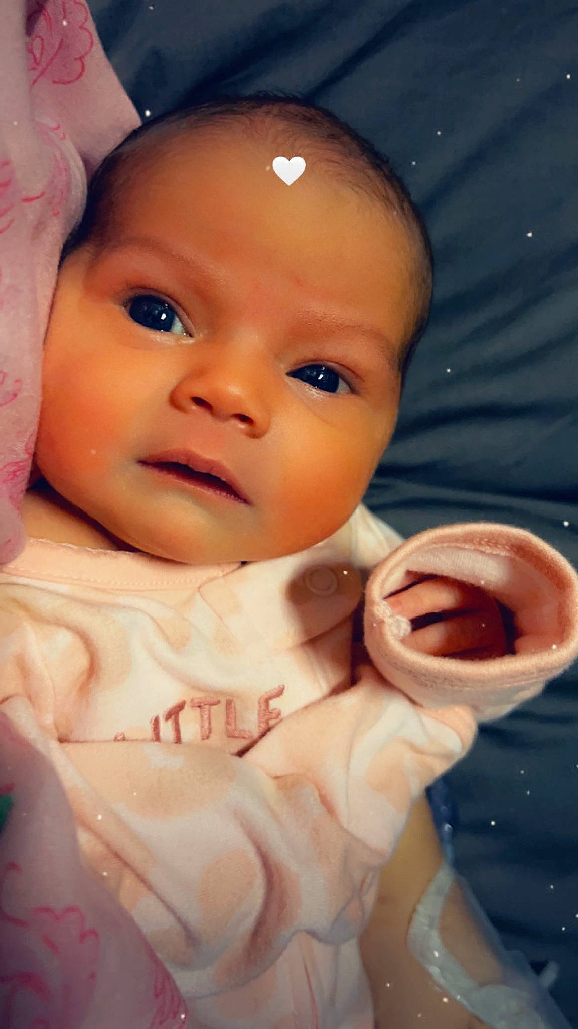 Mia is registered to the contest to win money with this photo: arm, baby, baby_toddler_clothing, cheek, child, eyelash, finger, gesture, happy, human_body, lip, mouth, nail, nose, person, pink, skin, smile, thumb, toddler