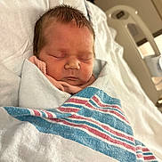 Ainsley Moate is registered to the contest to win money with this photo: newborn, baby, sleeping, blanket, hospital, bed, infant, wrapped, soft_lighting, peaceful, cute, child, portrait, closeup, healthcare, resting, pink_clothing, cozy, indoor, person