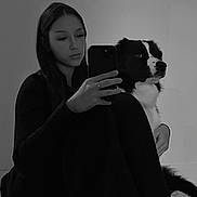 Vaia participe au concours pour gagner de l'argent avec cette photo : woman, dog, black_and_white, selfie, phone, sitting, indoor, pet, long_hair, casual_clothing, calm, portrait, fur, friendship, reflection, monochrome, relaxed, companion, floor, blanket