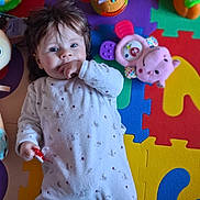 Ambre participe au concours pour gagner de l'argent avec cette photo : baby, bright_colors, child, colorful_mat, comfort, cute, floor, foam_puzzle, hand_in_mouth, happy, indoor, infant, lying_down, onesie, pacifier, playtime, smiling, soft_toy, toy, young_child