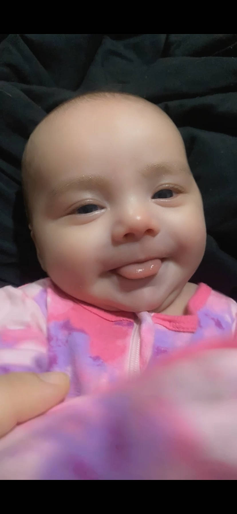 Babygirl is registered to the contest to win money with this photo: baby, baby_toddler_clothing, cheek, child, chin, dress, eye, eyebrow, eyelash, facial_expression, finger, happy, iris, joy, lip, mouth, nose, person, pink, skin