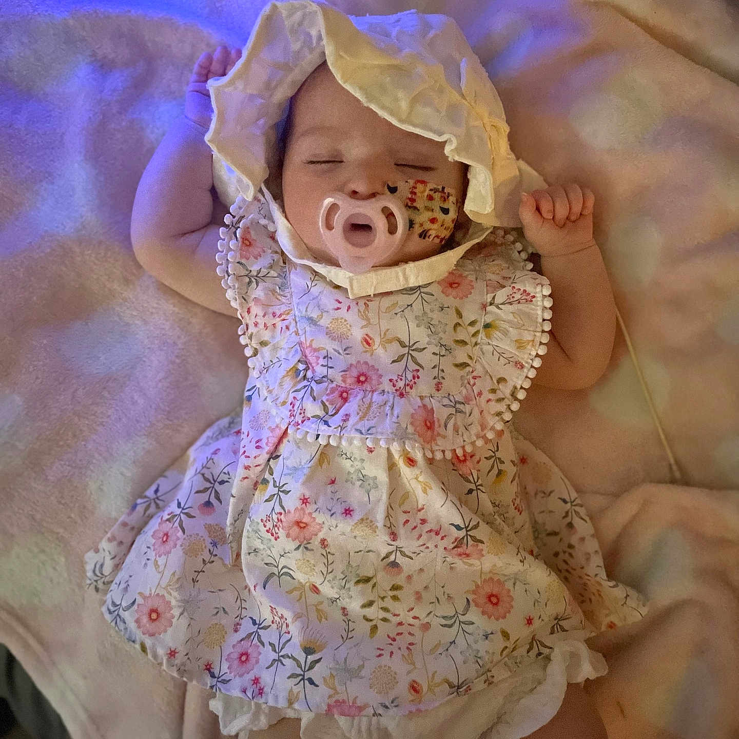 Aria is registered to the contest to win money with this photo: baby, bed, blanket, bodypart, bonnet, cap, clothing, costume, dress, face, finger, furniture, hand, hat, head, newborn, person, photography, portrait, sitting