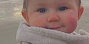 Lyzio participe au concours pour gagner de l'argent avec cette photo : baby, infant, child, towel, beach, ocean, waves, sand, blue_eyes, chubby_cheeks, face, portrait, wrapped, hand, holding, blanket, shore, sunset, outdoors, smile