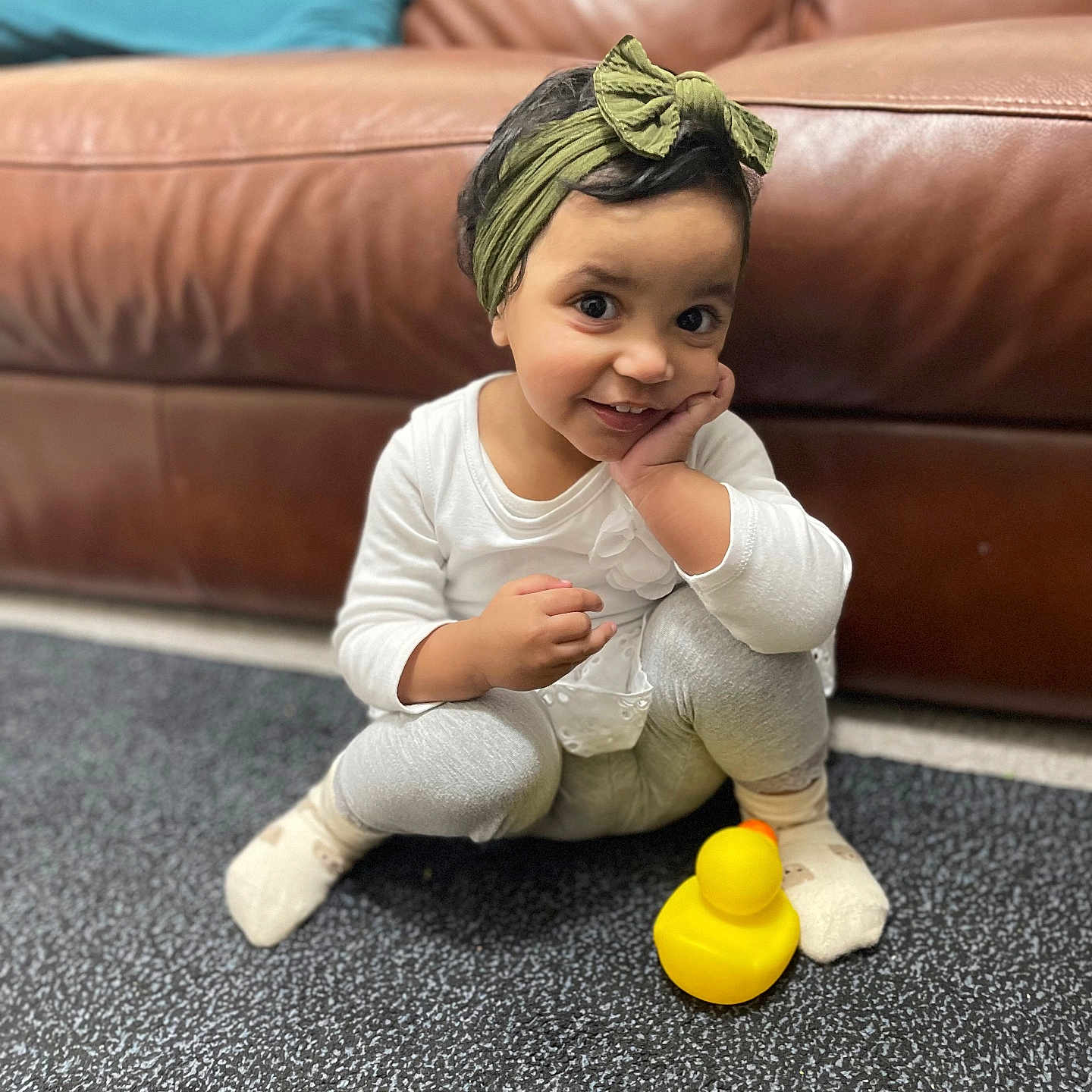 Fatma is registered to the contest to win money with this photo: architecture, baby, bodypart, building, clothing, couch, face, finger, furniture, happy, head, indoors, livingroom, pants, person, photography, portrait, room, sitting, smile