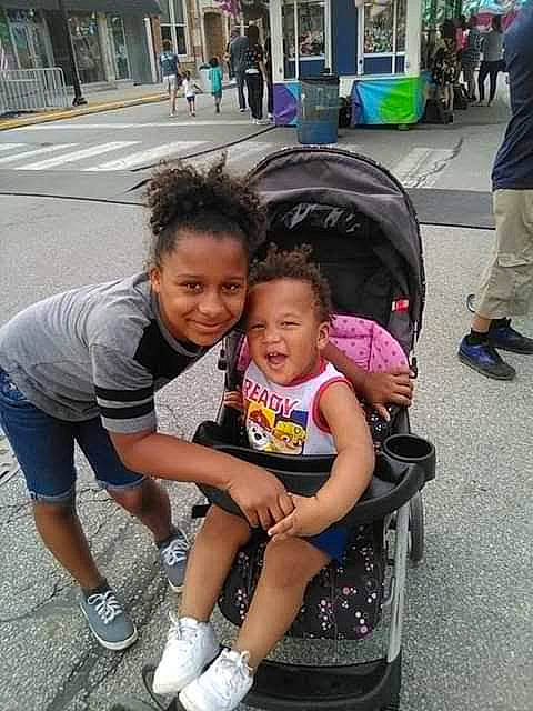 Jaziah Davis is registered to the contest to win money with this photo: baby_carriage, baby_products, child, daughter, joy, leisure, people, person, photography, play, product, recreation, smile, snapshot, street, summer, toddler, tourism, vacation, vehicle