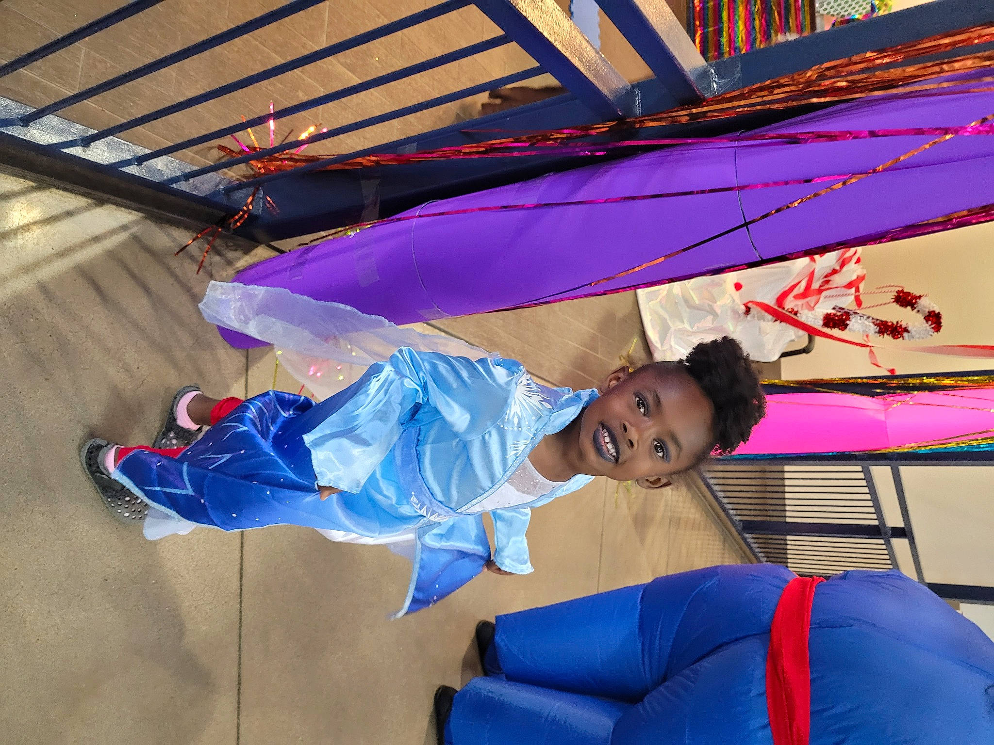 Monica is registered to the contest to win money with this photo: child, electric_blue, event, fashion_accessory, fun, happy, joy, leisure, magenta, orange, person, purple, recreation, red, smile, tints_and_shades, tree, umbrella