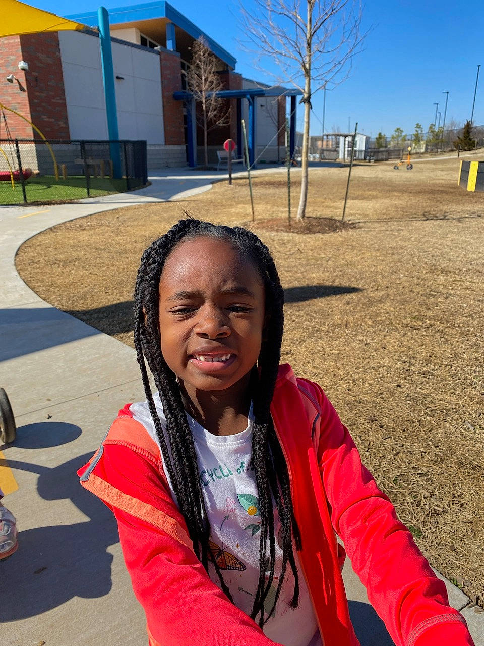 Monica is registered to the contest to win money with this photo: asphalt, child, city, community, cool, facial_expression, fun, happy, jewellery, leisure, mouth, person, personal_protective_equipment, photograph, plant, public_space, recreation, sky, travel, tree