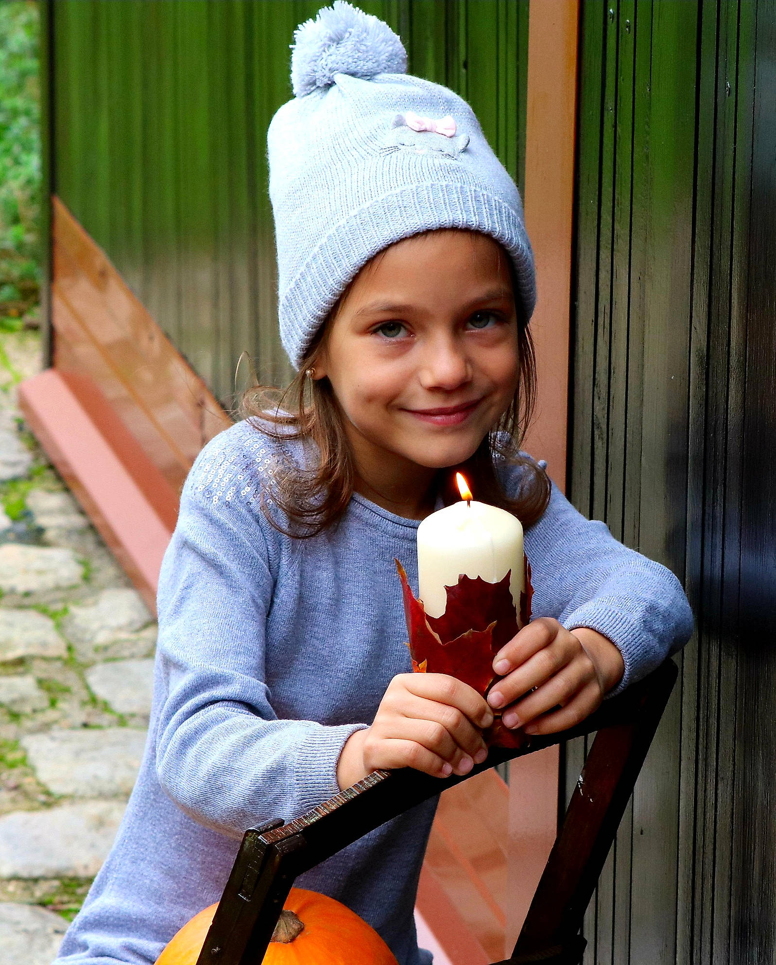 Milana participe au concours pour gagner de l'argent avec cette photo : brown_hair, cap, child, clothing, cool, drink, face, fashion_accessory, fun, glove, green, hand, happy, headgear, headwear, joy, knit_cap, lip, person, sitting