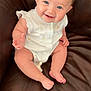 baby, blue_eyes, child, chubby_arms, chubby_legs, cute, feet, furniture, hands, happy, head, indoor, infant, leather_couch, portrait, sitting, skin, smiling, white_outfit, young