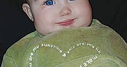 Hayzleigh joined the competition — help win amazing prizes! baby, blue_eyes, cheeks, child, close_up, clothing, cute, eyelashes, face, flash, fuzzy_blanket, green_clothing, happy, head, indoor, infant, portrait, sitting, smile, young_child