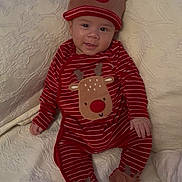 Finn Rey is registered to the contest to win money with this photo: baby, child, infant, smile, reindeer, hat, pajamas, red, white, striped, footwear, couch, blanket, holiday, christmas, cute, indoors, cozy, face, person